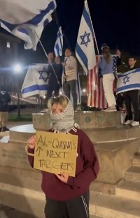 Pro-Palestinian demonstrator holds threatening sign
