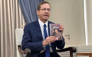 Israeli President Isaac Herzog holds up copy of<br />Mein Kampf found in children’s room